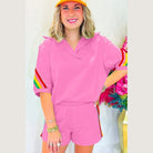YNIQUE pink lounge set with rainbow stripes on sleeves and shorts featuring green colorblock lounge set