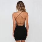 Back view of a woman wearing a black halter bandage club dress with crisscross straps and open back