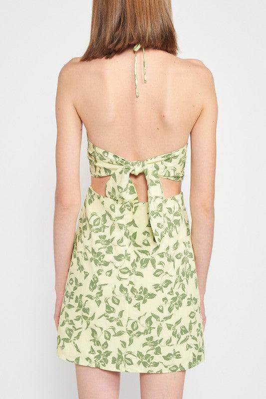 Back view of Emory Park halter neck floral mini dress with a tie design and leafy green pattern