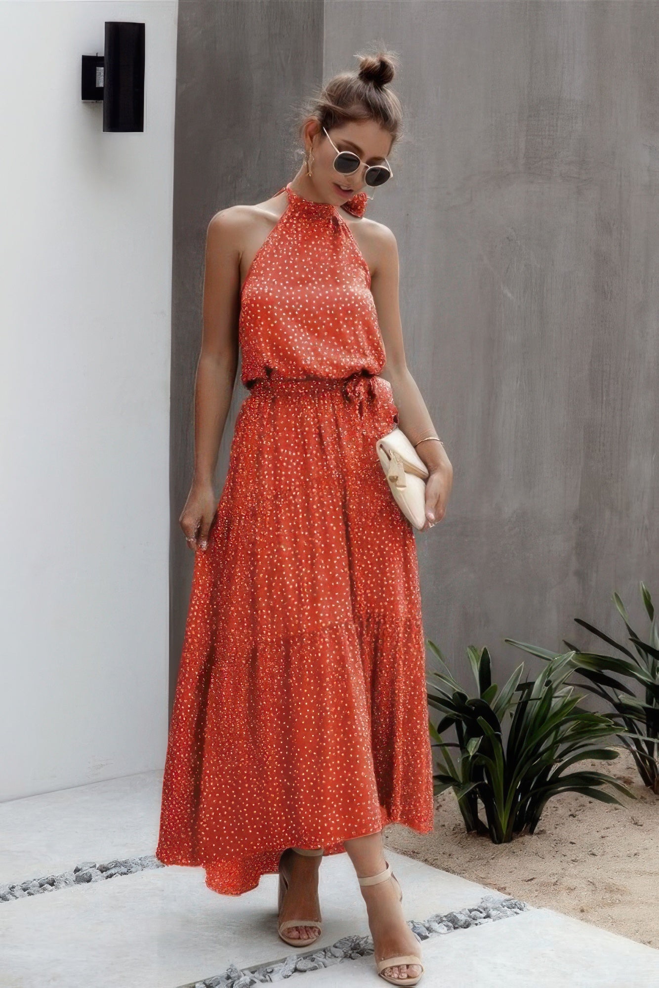 Stylish halter neck polka dot dress in red with a flowy skirt, perfect for summer outings