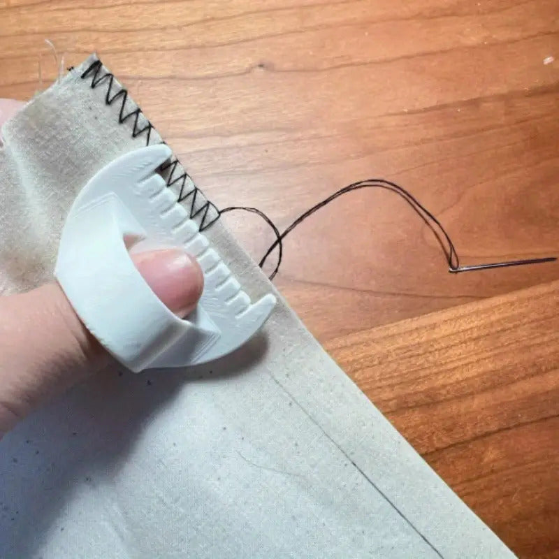 Hand-sewing needles with fabric and thread, ideal for stitching projects