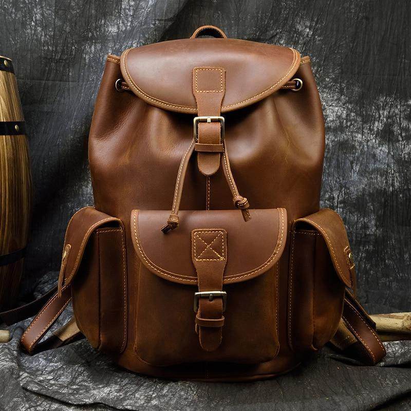 Handcrafted leather backpacks men women in rich brown with utility pockets and adjustable straps