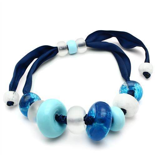 Handmade blue beaded necklace featuring varying shades of blue and white glass beads on a satin ribbon