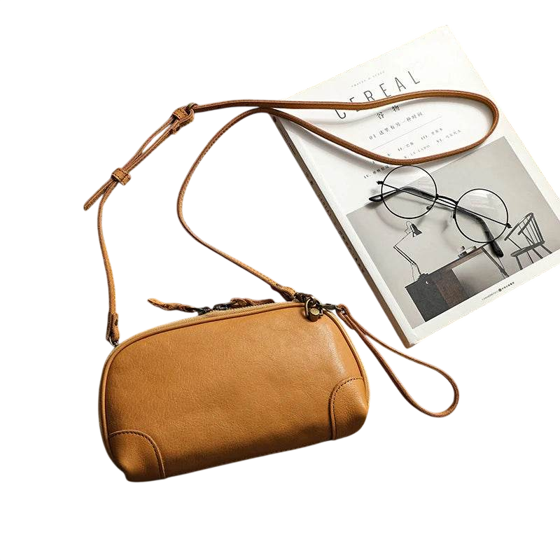 Brown leather crossbody bag on a white background