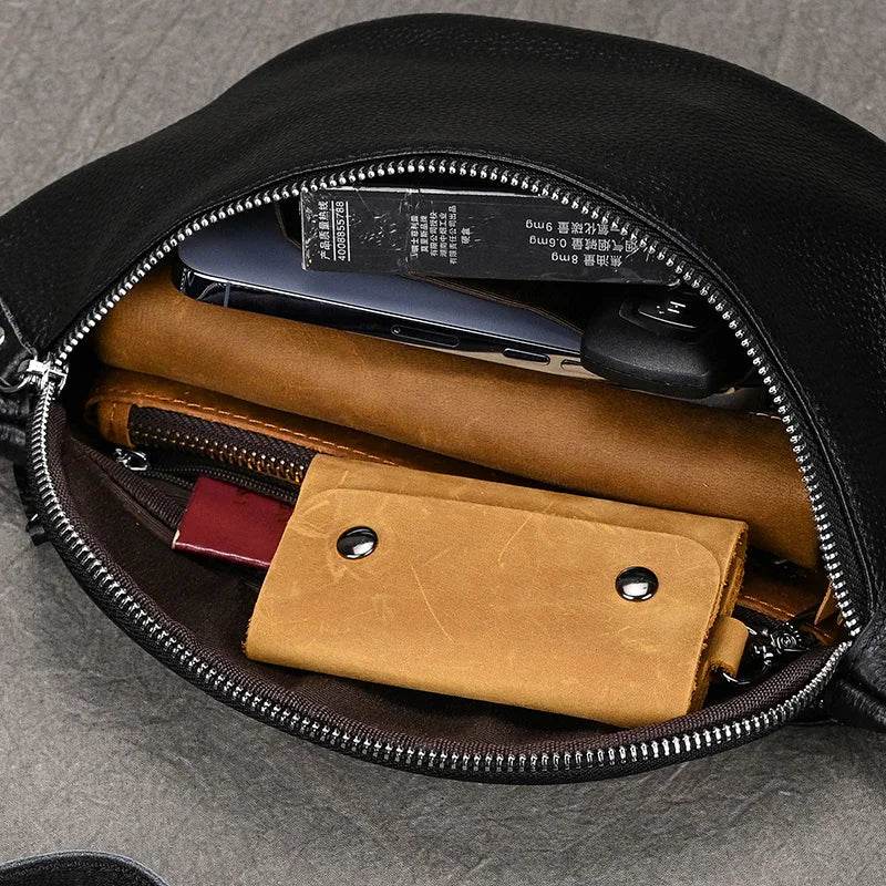 Inside view of hands-free leather fanny pack showing organized compartments for essentials like phone and wallet