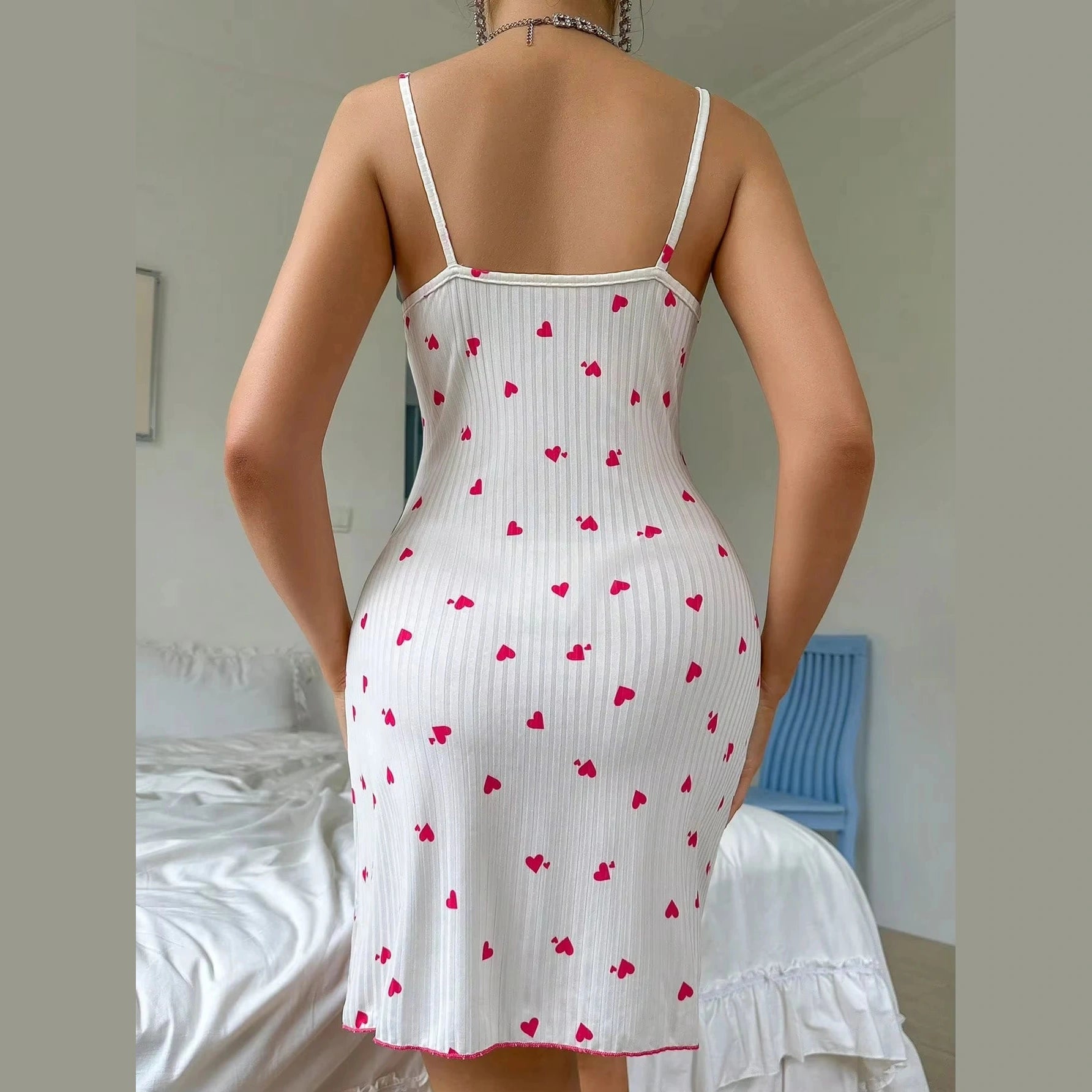 Back view of a heart print sleep dress for ladies in white with red heart patterns and thin straps