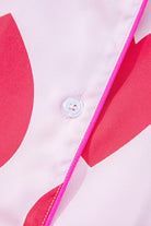 Close-up of button and pink piping detail on heart print valentine pajamas set by YNIQUE