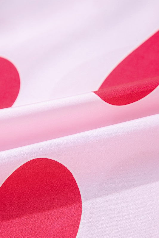 Close-up view of soft fabric with red heart pattern from heart print valentine pajamas set by YNIQUE