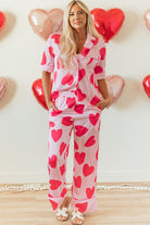 YNIQUE heart print valentine pajamas set with red hearts on pink fabric worn by woman