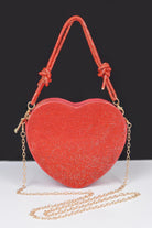 Heart shaped evening purse in red with a sparkling finish and a gold chain strap for stylish outings