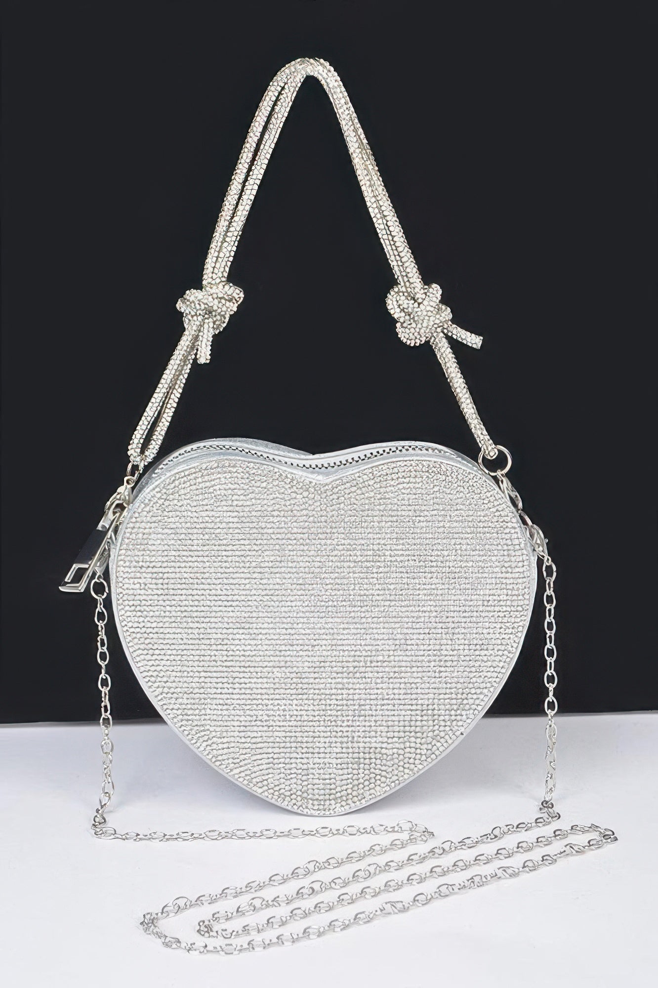 Shiny heart shaped evening purse with sparkling rhinestones and silver chain strap for formal occasions