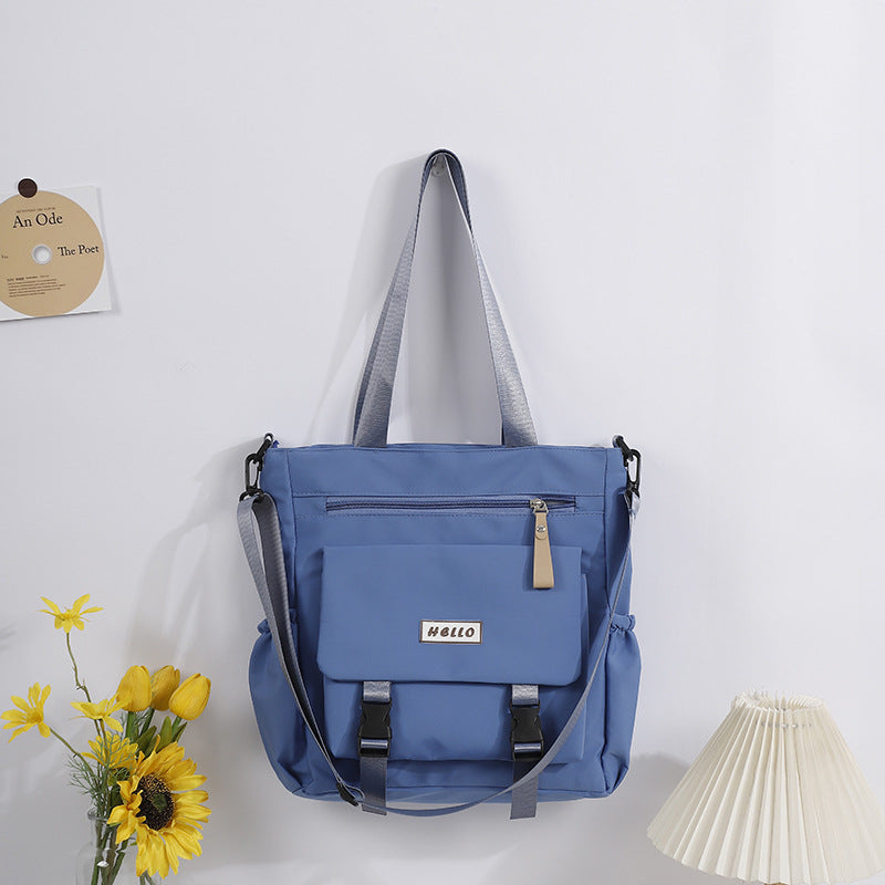 Stylish large capacity tote bag in blue with adjustable straps and front pocket for everyday use