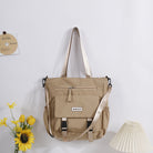 Stylish large capacity tote bag in beige with adjustable straps and front pocket for easy access