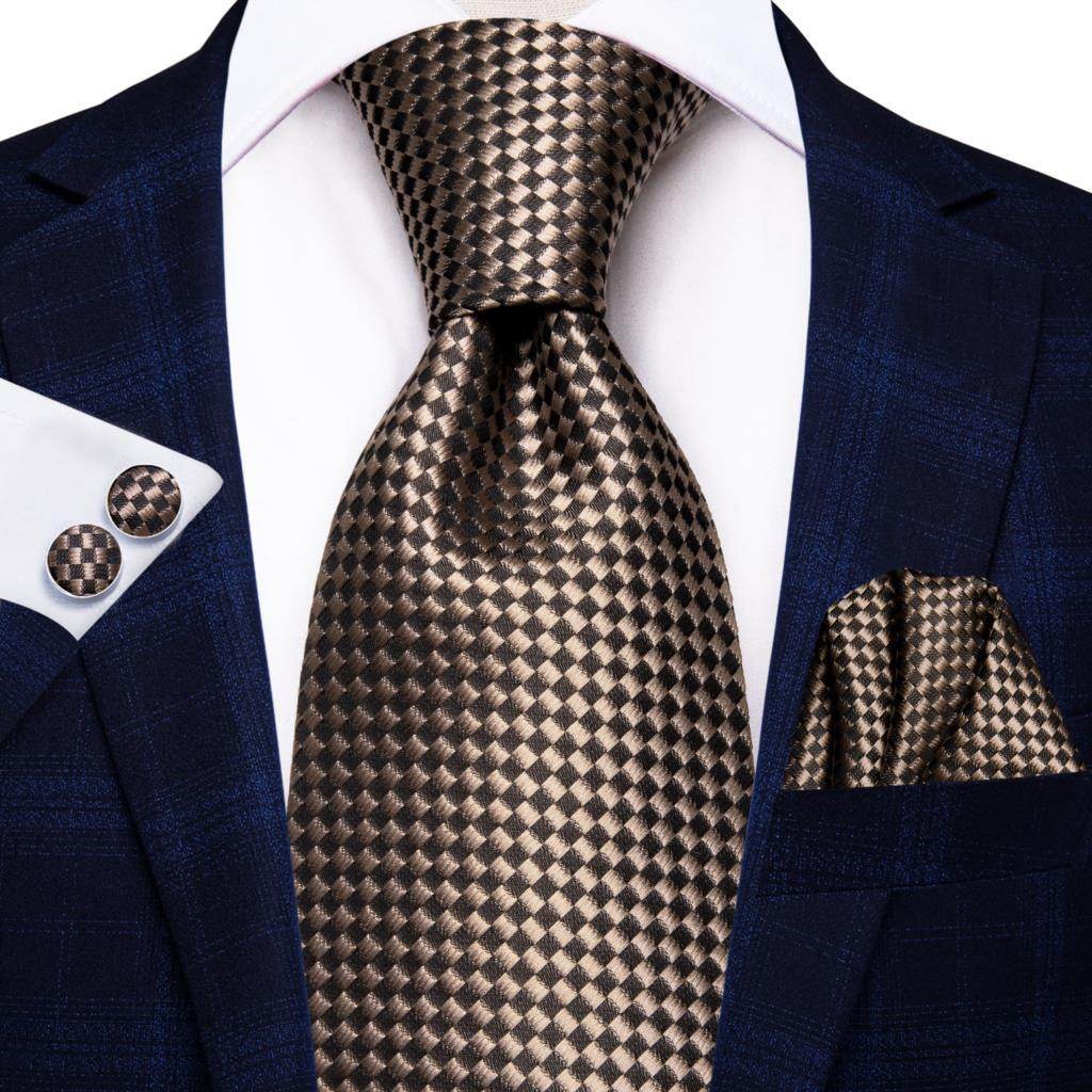 Gold paisley formal tie paired with a dark suit and patterned pocket square for a sophisticated look