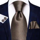 Gold paisley formal tie paired with a dark suit and patterned pocket square for a sophisticated look