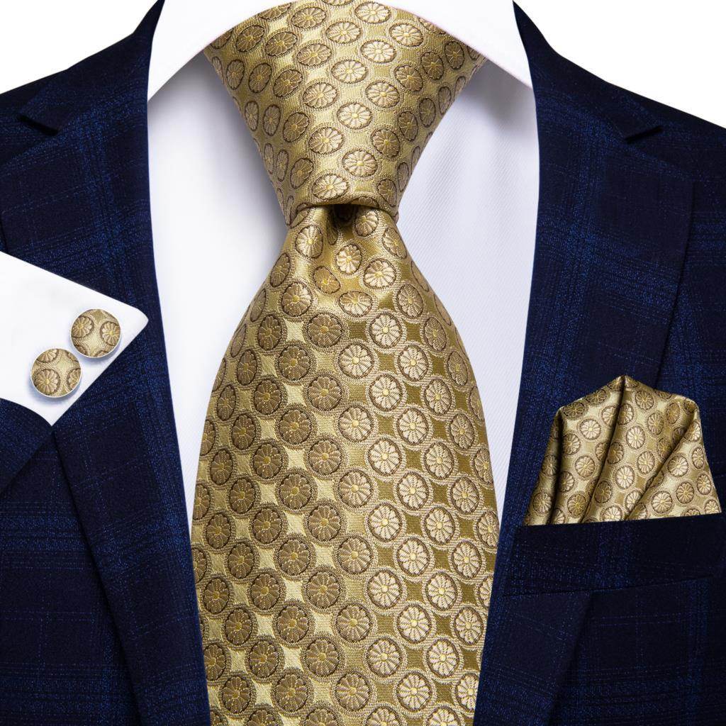 Gold paisley formal tie paired with a navy suit and matching pocket square for elegant looks