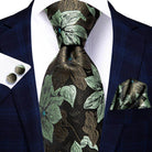 Gold paisley formal tie paired with a stylish dress shirt and pocket square for an elegant look