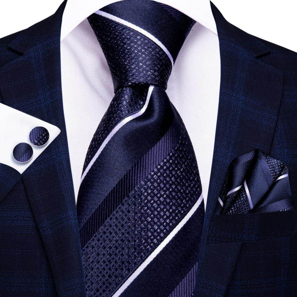 Elegant gold paisley formal tie paired with a navy suit and pocket square for a sophisticated look