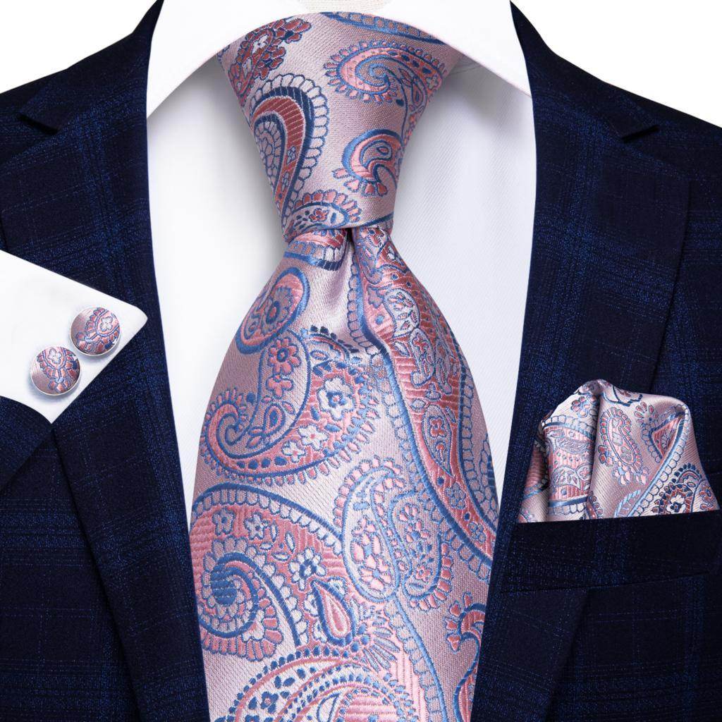 Gold paisley formal tie elegantly styled with a matching pocket square and cufflinks on a dark suit