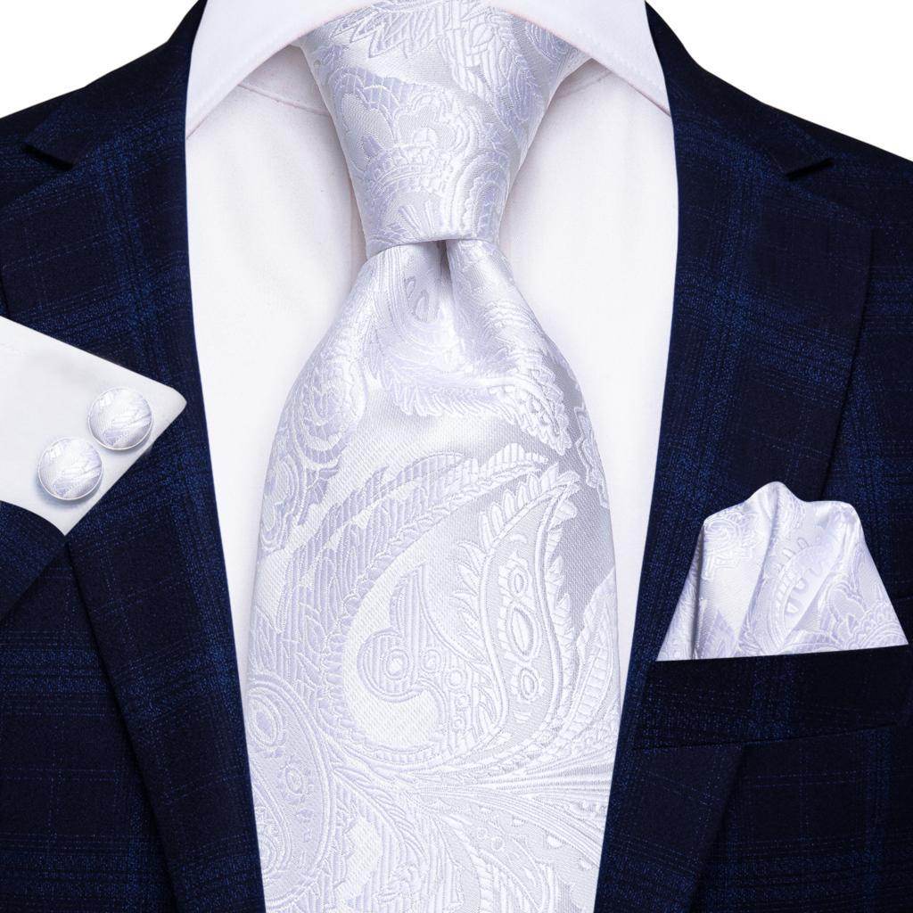 Gold paisley formal tie elegantly styled with a white dress shirt and navy suit, perfect for special occasions