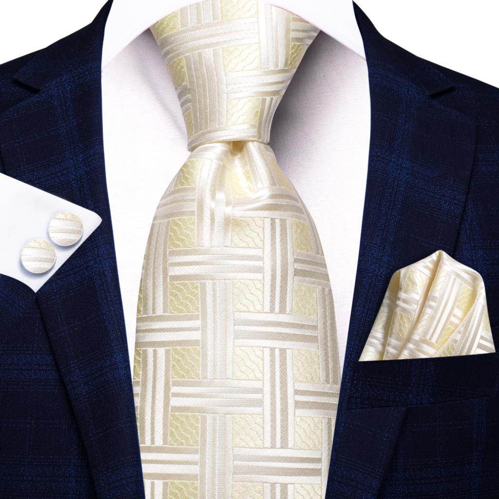 Elegant gold paisley formal tie paired with a stylish suit and pocket square for sophisticated looks