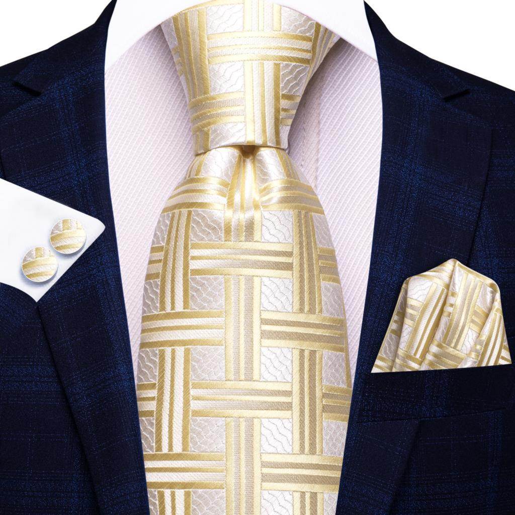 Gold paisley formal tie paired with a stylish suit and matching pocket square and cufflinks