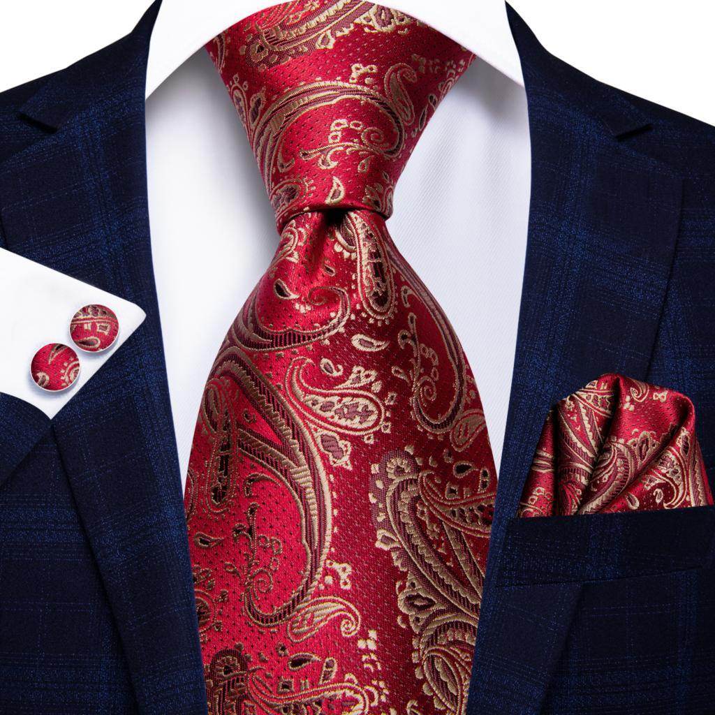 VacationGrabs striped silk necktie in red with intricate gold paisley design, styled with a navy suit