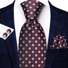 VacationGrabs striped silk necktie in deep maroon with circular patterns, styled with matching pocket square and cufflinks