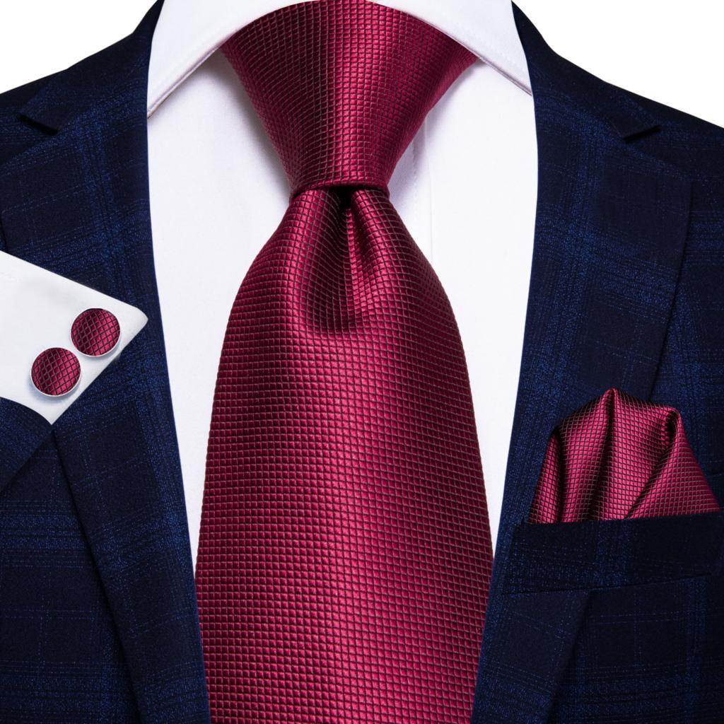 Elegant maroon striped silk necktie paired with a stylish suit and pocket square