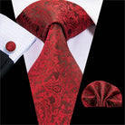Elegant red paisley design striped silk necktie paired with matching pocket square for formal occasions