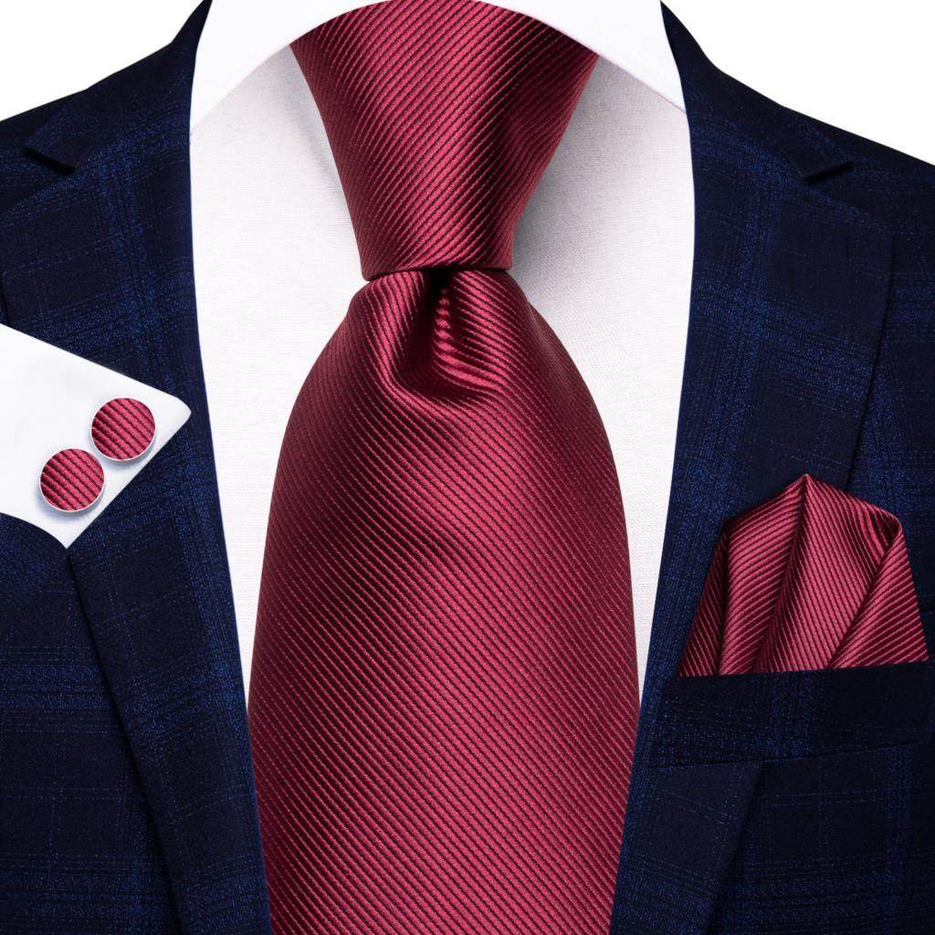 VacationGrabs striped silk necktie in burgundy paired with a stylish suit jacket and pocket square