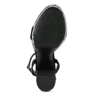 Sleek black high heel vacation sandals with stylish straps and a sturdy sole for summer outings