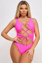 VacationGrabs high leg bathing suit with tie front in vibrant pink with cutout design