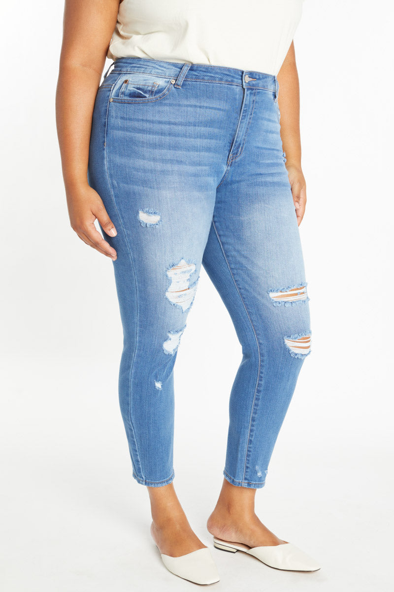 Women's high rise jeans in light blue denim with distressed details