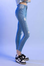 Women's high rise skinny jeans in light blue denim, casual wear