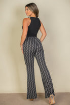 VacationGrabs high waist bell bottoms for women in black and white wavy pattern worn with sleeveless black top