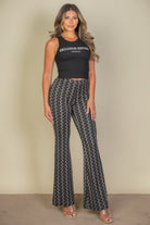 VacationGrabs high waist bell bottoms for women in black and white pattern paired with black sleeveless top