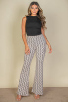 Woman wearing high waist bell bottoms for women with a black sleeveless top and open-toe heels
