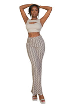 VacationGrabs high waist bell bottoms for women with wave pattern paired with white crop top and sandals