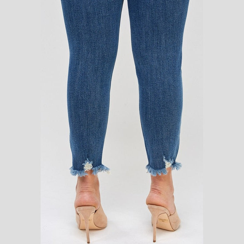 Women's high waisted plus size distressed denim jeans with frayed hem for a trendy look