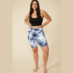 Woman wearing ALAMAE Apparel high waisted tie dye biker shorts in black and white with a black crop top