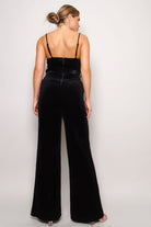 Stylish black holiday party jumpsuit outfit with back zipper and wide-leg design