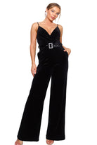 Black velvet women's holiday party jumpsuit outfit featuring a belted waist and elegant neckline