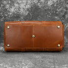 Bottom view of a hot leather carry-on bag with protective feet, perfect for travel