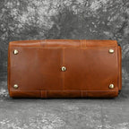 Bottom view of a hot leather carry-on bag with protective feet, perfect for travel