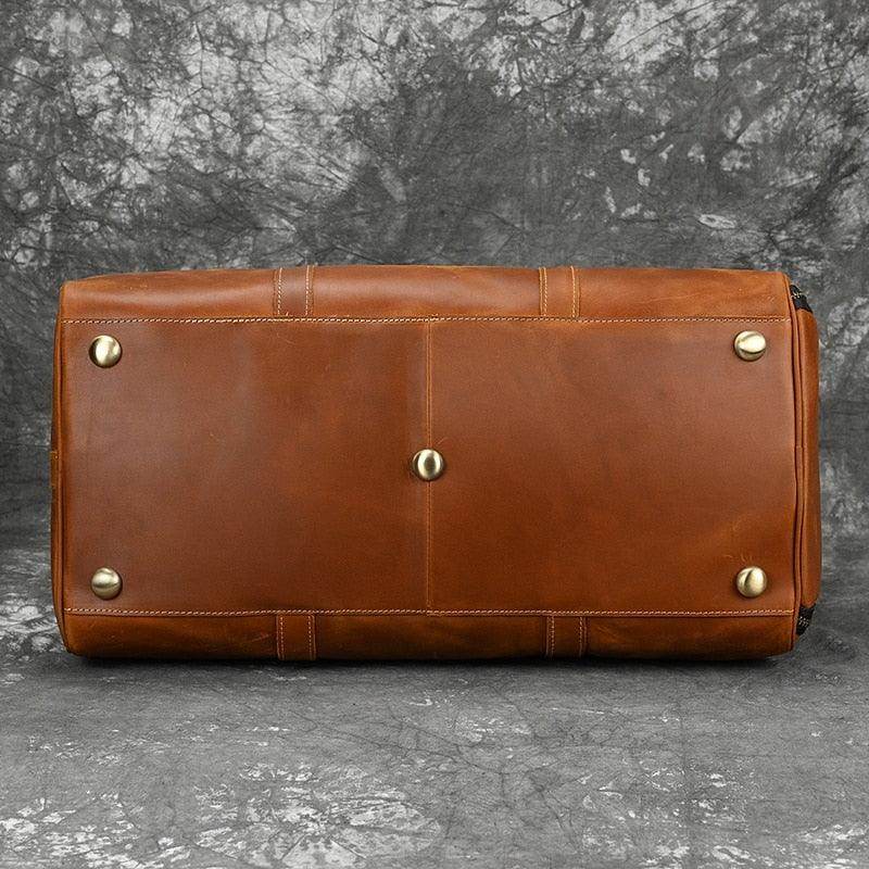 Bottom view of a hot leather carry-on bag with protective feet, perfect for travel