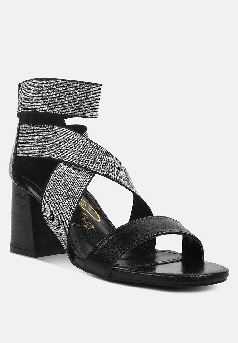 Black sandal with criss-cross straps on a white background