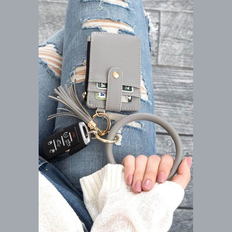 Gray ID holder keychain bracelet with a wallet and car keys for stylish accessory organization