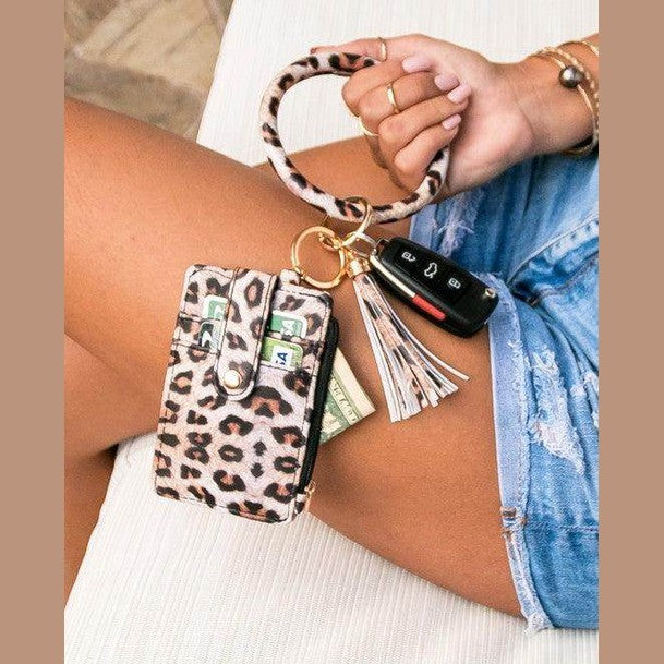 Stylish leopard print ID holder keychain bracelet with a tassel and space for cash and keys