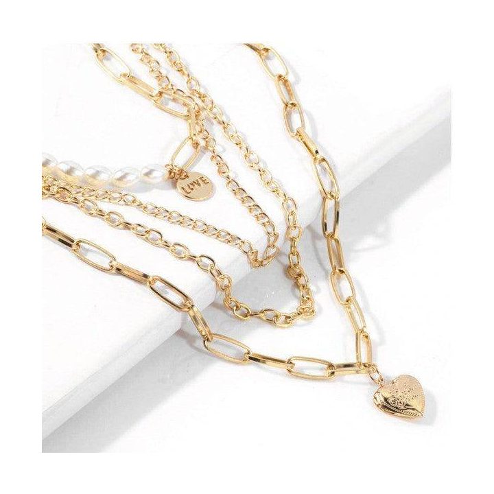Elegant jester necklace for women featuring layered gold chains and heart pendant for a stylish look